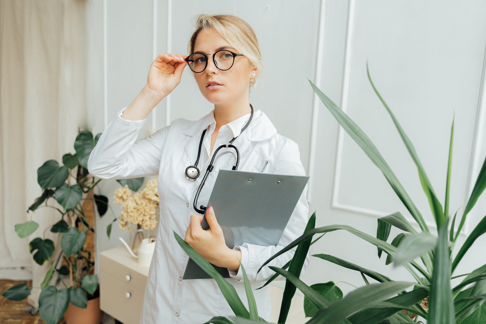 Doctor Wearing a Eyeglasses and Holding a Clipboard